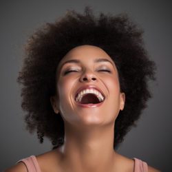 A beautiful woman laughing on a gray background