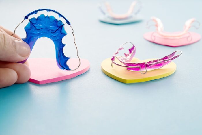 Dental retainer orthodontic appliance on the blue background Invisalign cosmetic dentistry dentist in Nixa Missouri